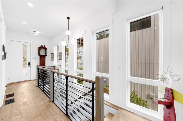 10862 Serenbe Ln, Chattahoochee Hills, GA 30268 - hallway with an upstairs landing, healthy amount of natural light, light wood-style floors, and recessed lighting