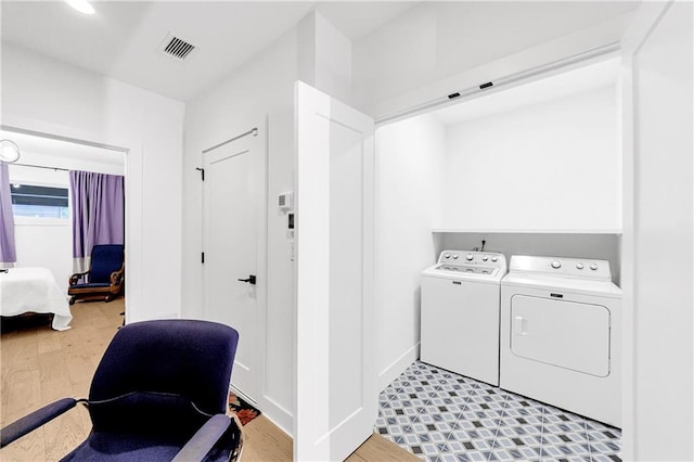 10862 Serenbe Ln, Chattahoochee Hills, GA 30268 - laundry room with washing machine and clothes dryer and light wood-type flooring