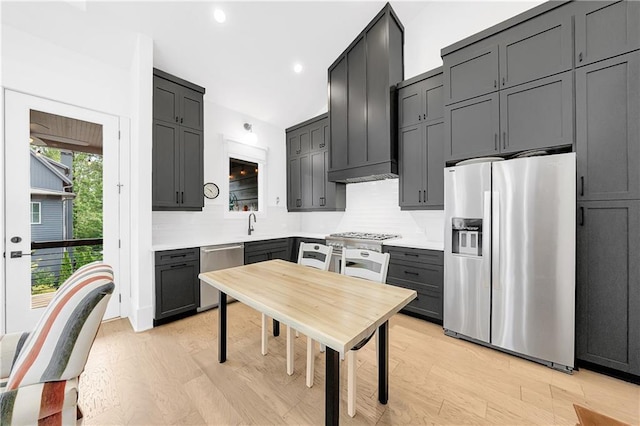 10862 Serenbe Ln, Chattahoochee Hills, GA 30268 - kitchen featuring stainless steel appliances, light wood finished floors, decorative backsplash, recessed lighting, and light countertops
