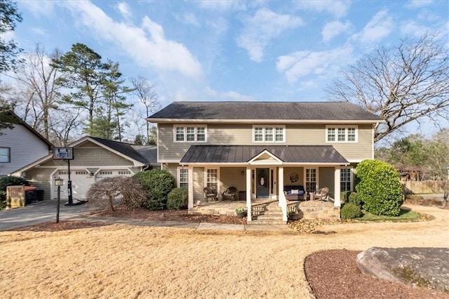 view of front of property featuring a garage and covered porch