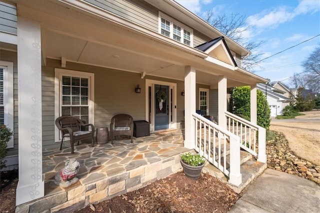 view of exterior entry with a porch