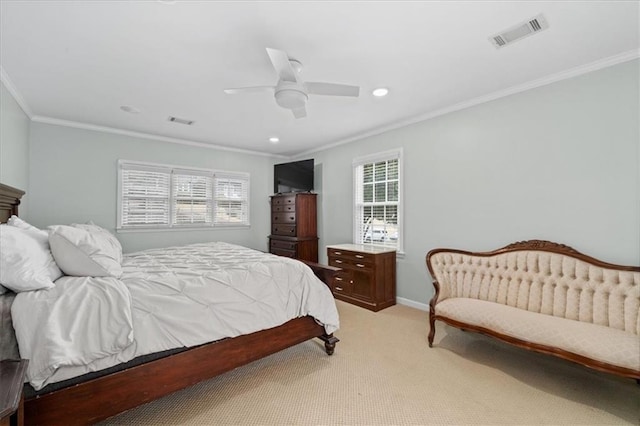 carpeted bedroom with ceiling fan and ornamental molding