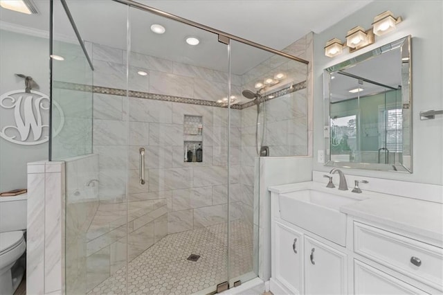 bathroom featuring vanity, toilet, and walk in shower