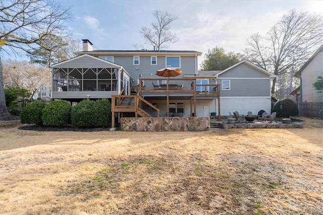 back of house with a sunroom and a deck