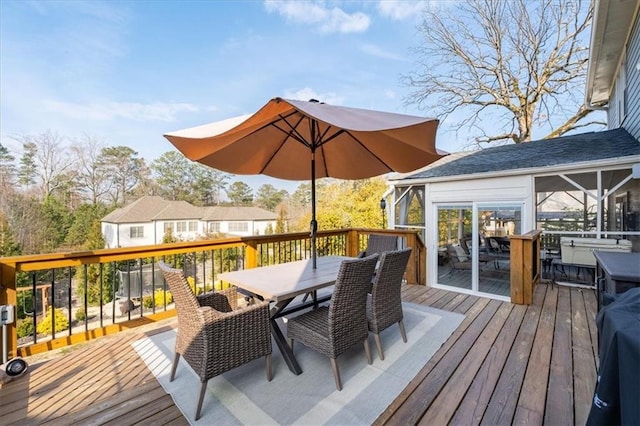 wooden deck with a sunroom