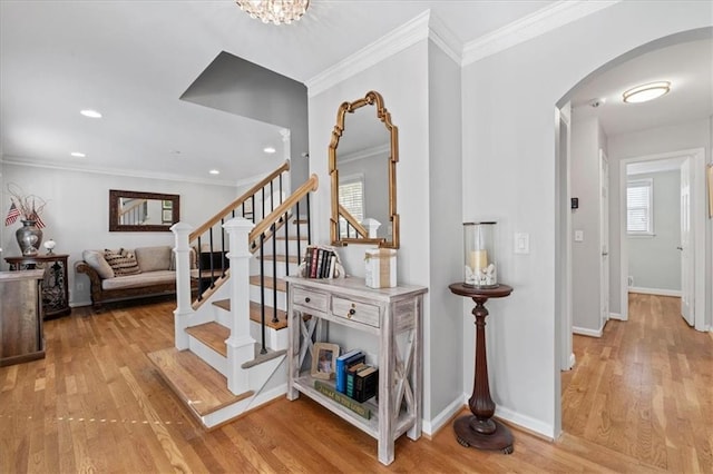 staircase with wood-type flooring and ornamental molding