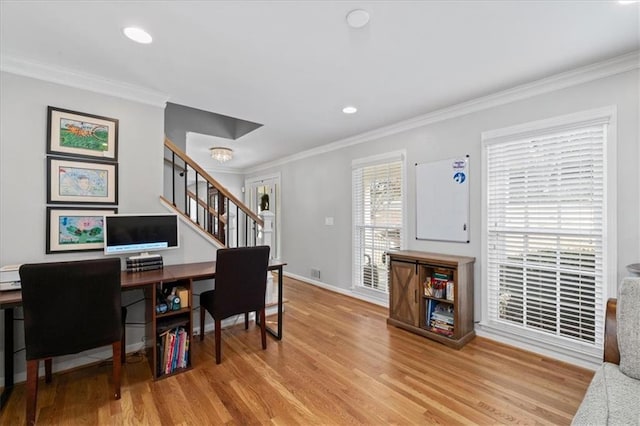 home office with crown molding and light hardwood / wood-style flooring