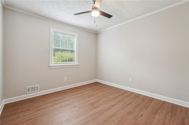 spare room featuring visible vents, a textured ceiling, light wood-style flooring, and baseboards