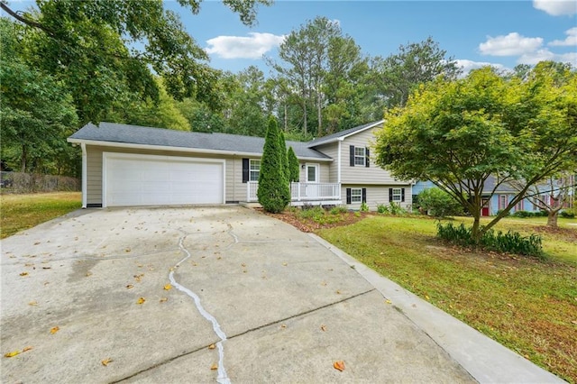 split level home with an attached garage, driveway, and a front yard