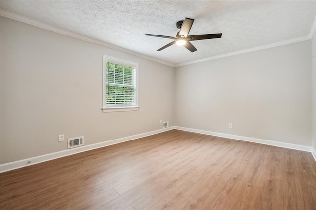 empty room featuring visible vents, a ceiling fan, baseboards, and wood finished floors