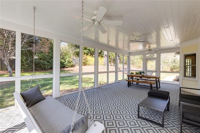 sunroom / solarium featuring wood ceiling and a ceiling fan