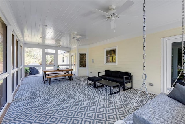 sunroom with wooden ceiling and a ceiling fan