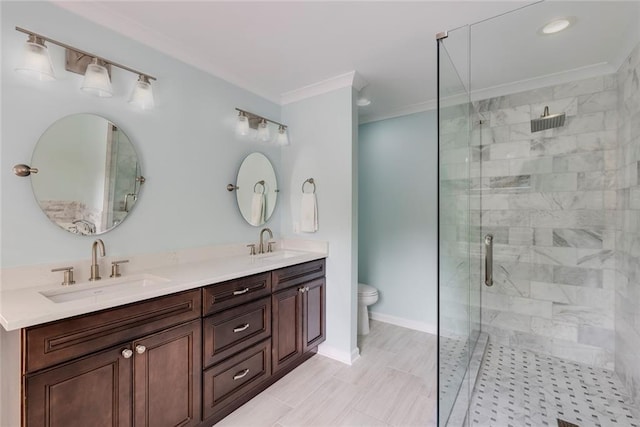 full bath featuring ornamental molding, a stall shower, baseboards, and a sink