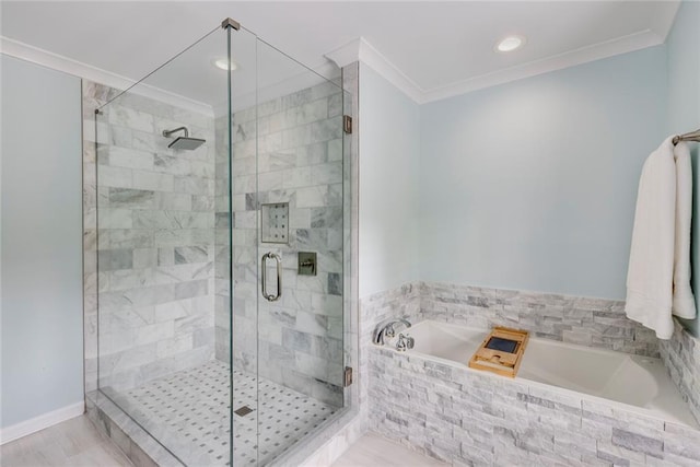 full bathroom featuring baseboards, a garden tub, ornamental molding, and a shower stall