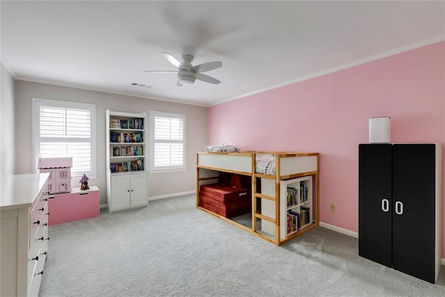 carpeted bedroom featuring visible vents, ceiling fan, crown molding, and baseboards