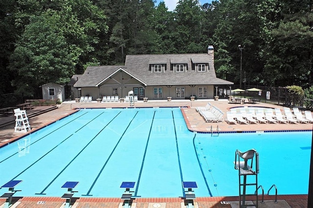 community pool featuring a patio and fence