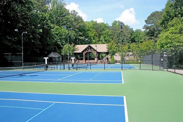 view of tennis court with fence