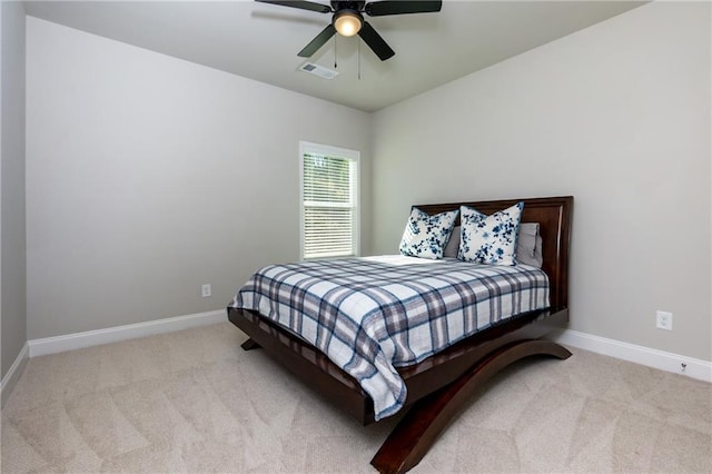 bedroom featuring light carpet and ceiling fan