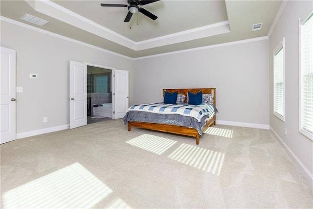carpeted bedroom with a raised ceiling, ceiling fan, and crown molding