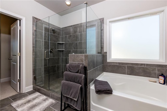 bathroom featuring tile patterned flooring and shower with separate bathtub