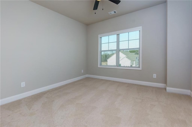 carpeted spare room with ceiling fan