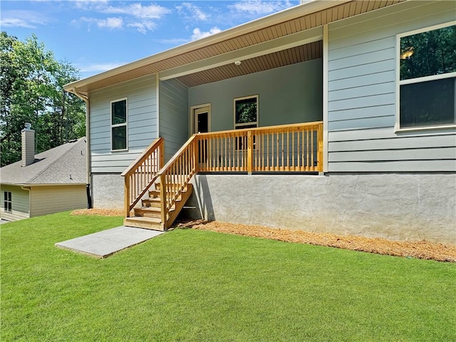 back of house with a lawn