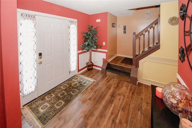 1801 Deer Crossing Cir, Jonesboro, GA 30236 - foyer with wood finished floors, stairs, baseboards, and a textured ceiling