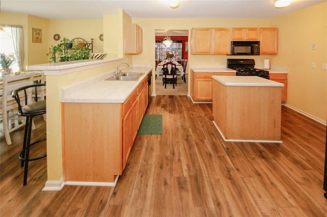 1801 Deer Crossing Cir, Jonesboro, GA 30236 - kitchen with black appliances, a sink, light countertops, and wood finished floors