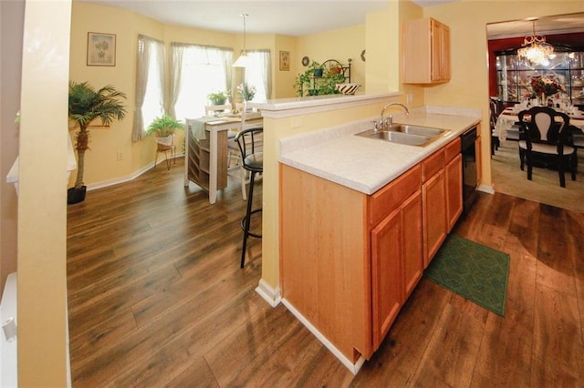 1801 Deer Crossing Cir, Jonesboro, GA 30236 - kitchen featuring a sink, dishwasher, dark wood finished floors, light countertops, and a breakfast bar