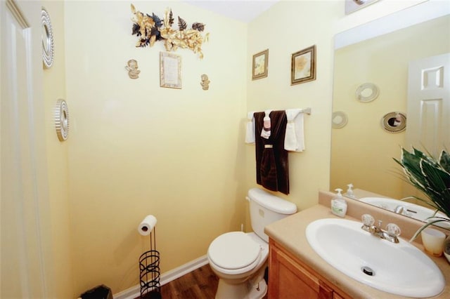 1801 Deer Crossing Cir, Jonesboro, GA 30236 - half bathroom featuring wood finished floors, toilet, baseboards, and vanity