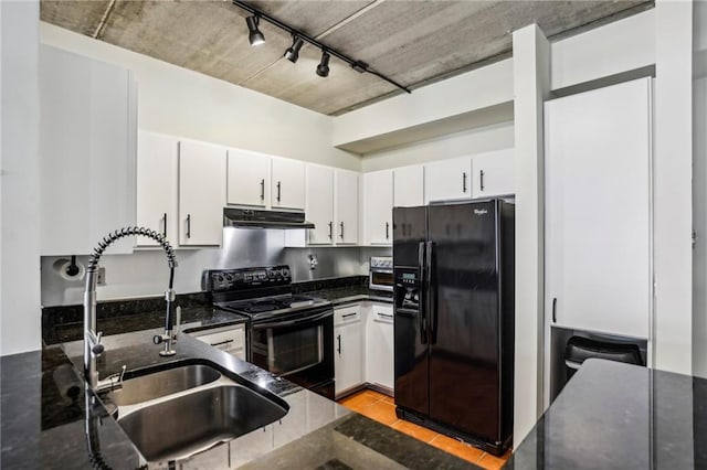 800 Peachtree St NE Unit 2304, Atlanta, GA 30308 - kitchen with black appliances, a sink, under cabinet range hood, dark stone counters, and white cabinetry