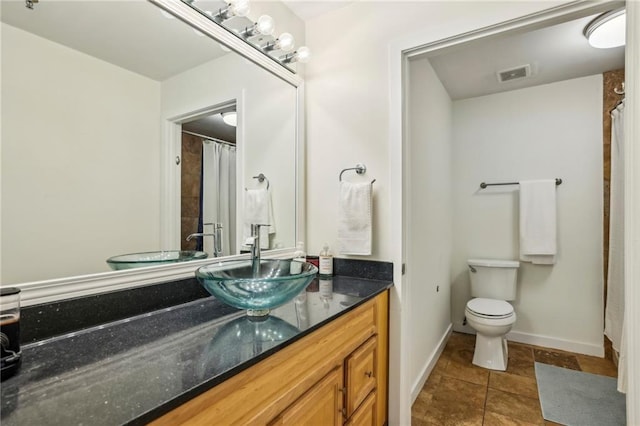 800 Peachtree St NE Unit 2304, Atlanta, GA 30308 - bathroom featuring toilet, vanity, baseboards, and tile patterned flooring