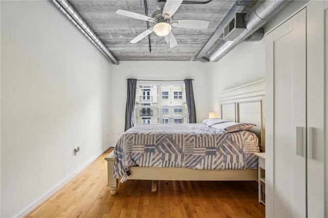 800 Peachtree St NE Unit 2304, Atlanta, GA 30308 - bedroom featuring wood finished floors, a ceiling fan, and baseboards