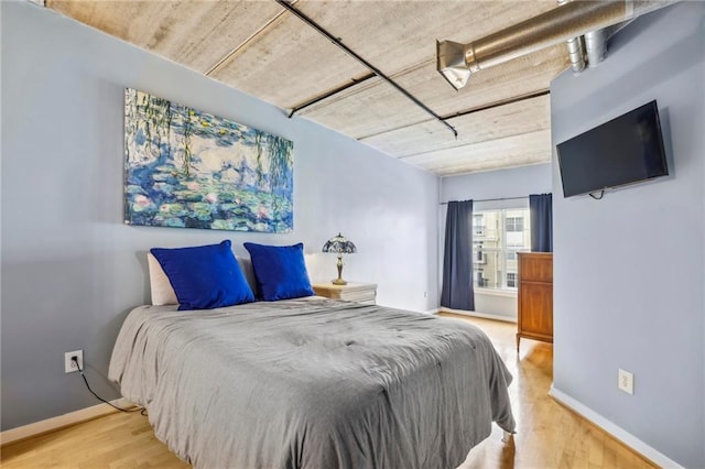 800 Peachtree St NE Unit 2304, Atlanta, GA 30308 - bedroom with wood finished floors and baseboards