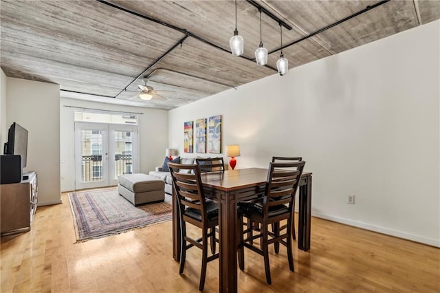 800 Peachtree St NE Unit 2304, Atlanta, GA 30308 - dining space featuring french doors, wood finished floors, a ceiling fan, and baseboards