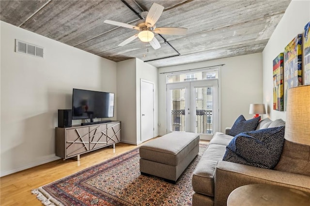 800 Peachtree St NE Unit 2304, Atlanta, GA 30308 - living room featuring french doors, wood finished floors, ceiling fan, and baseboards