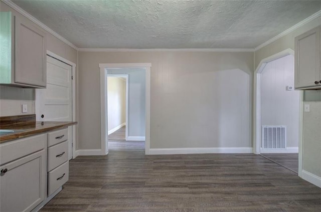2014 Maple Ave SW, Rome, GA 30161 - kitchen with dark wood-type flooring, ornamental molding, dark countertops, baseboards, and a textured ceiling