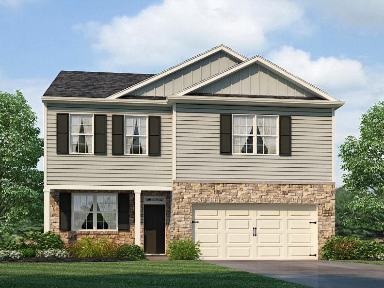 view of front of house featuring a garage and a front lawn