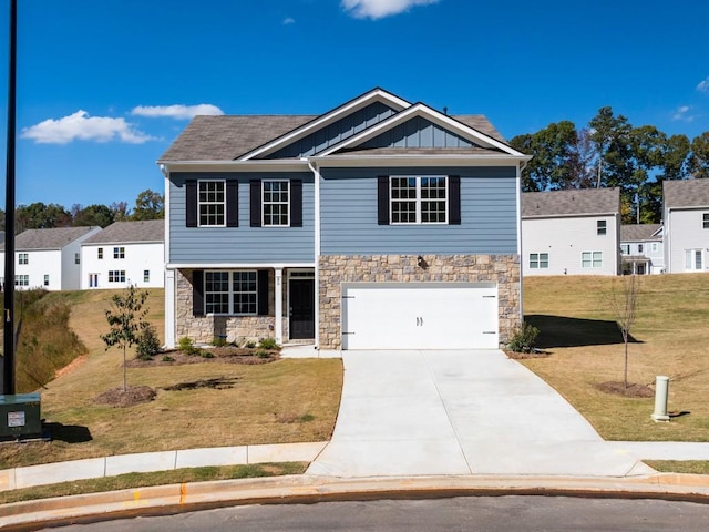 view of front of home with a garage and a front lawn