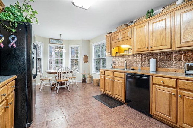 kitchen featuring pendant lighting, sink, decorative backsplash, light tile patterned floors, and black appliances