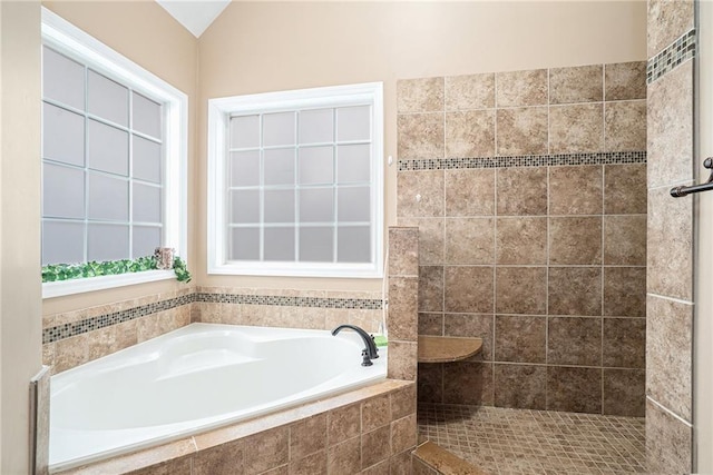 bathroom featuring shower with separate bathtub