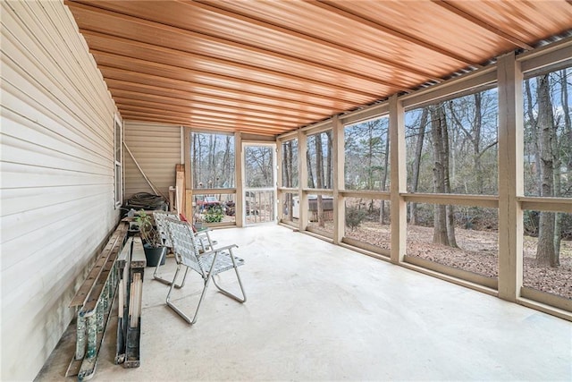 unfurnished sunroom with wooden ceiling