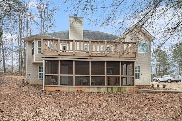 rear view of property with a sunroom