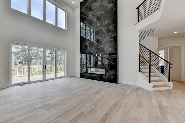 unfurnished dining area featuring a chandelier and light wood-type flooring