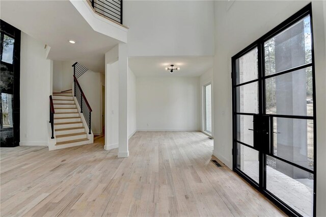 interior space with light hardwood / wood-style floors and a chandelier