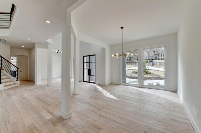 kitchen with sink, white cabinetry, hanging light fixtures, stainless steel appliances, and a center island