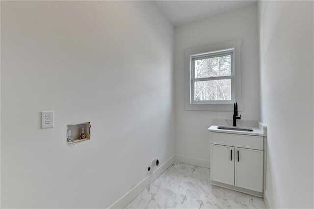 kitchen featuring gas stovetop, a center island, hanging light fixtures, a tray ceiling, and white cabinets