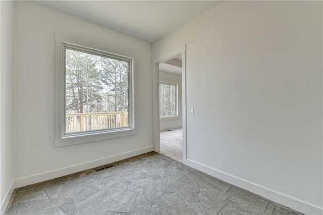 unfurnished room featuring a raised ceiling, ceiling fan, and light hardwood / wood-style floors