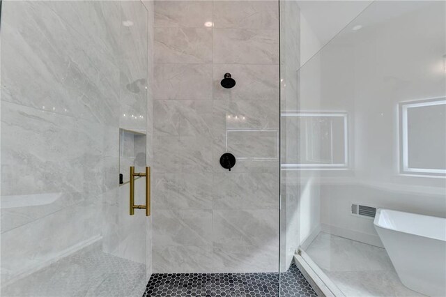 bathroom featuring vanity, a bathing tub, and a raised ceiling