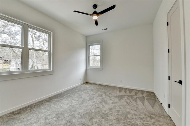 unfurnished bedroom featuring light colored carpet and ceiling fan